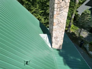 roof flashing leak around chimney Green metal roof meeting a stone chimney